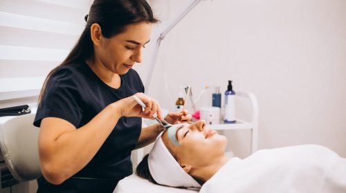 cosmetologist-applying-mask-face-client-beauty-salon cosmetologist-applying-mask-face-client-beauty-salon
